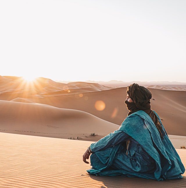 Man in dunes watch sunset