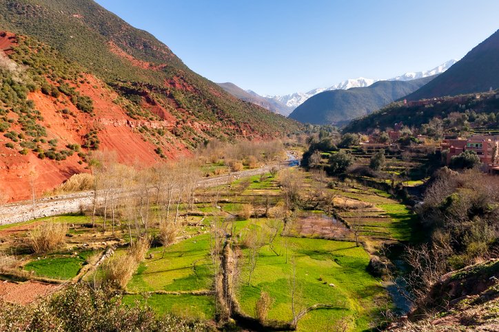 Ourika valley green fields and red rocks over river