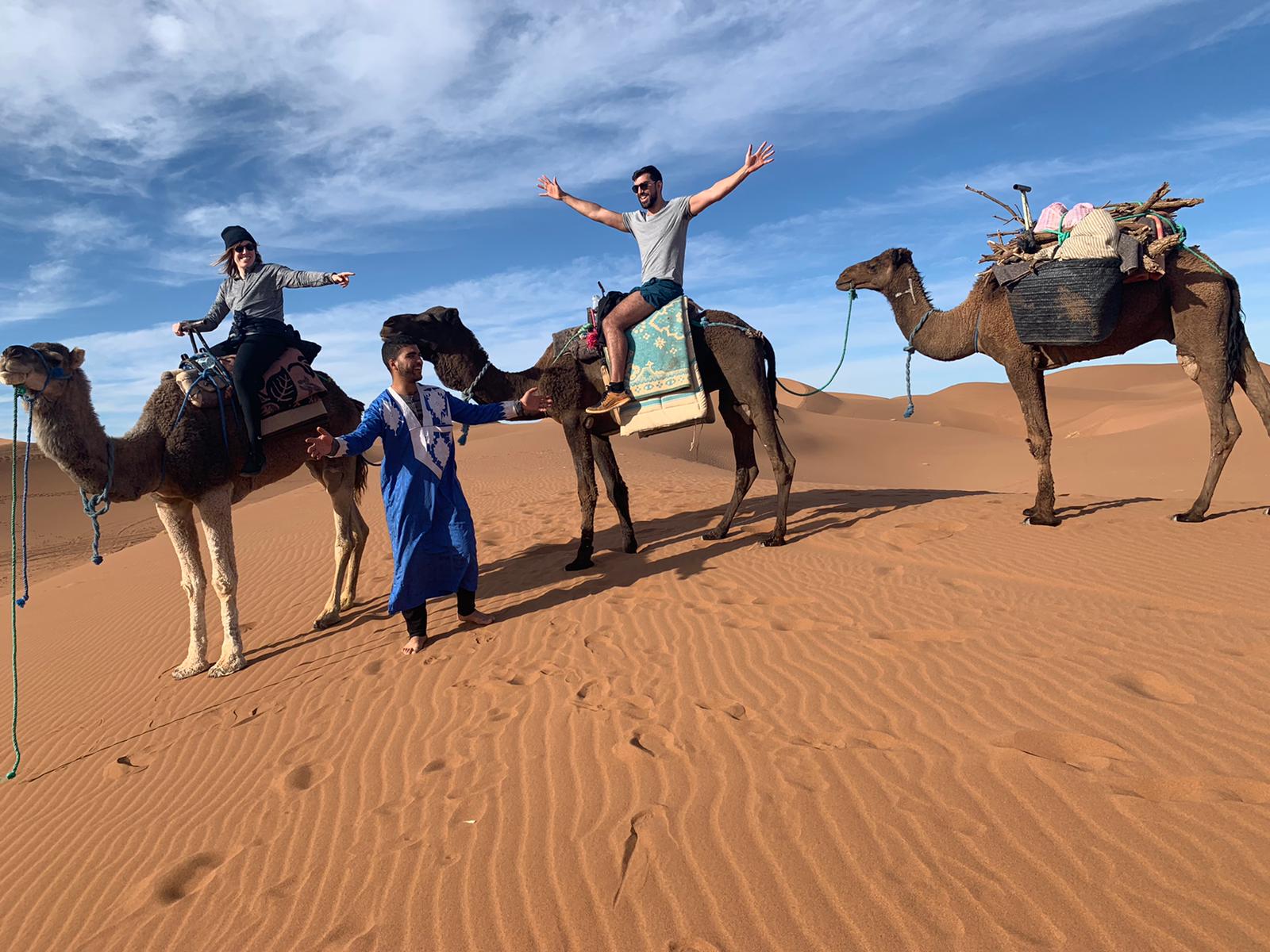 Jamal with travelers on a camel trek in the Sahara