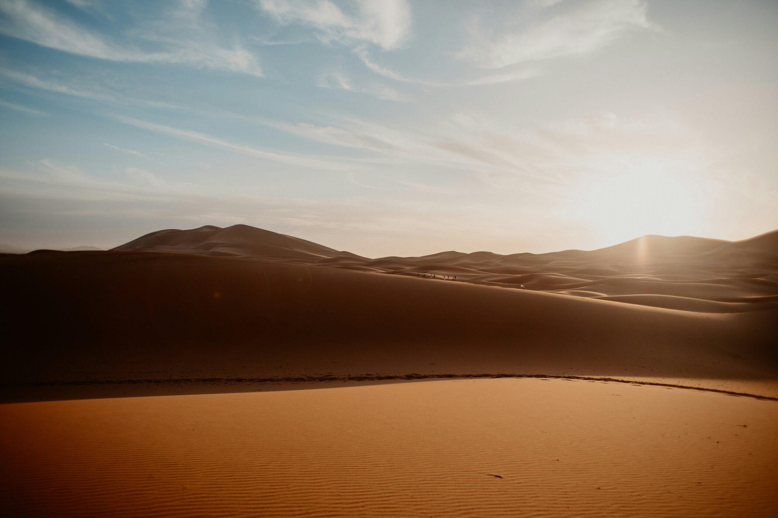 Golden sand dunes of the Sahara under a bright sky